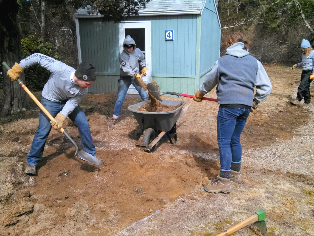 guys digging with wheelbarrow