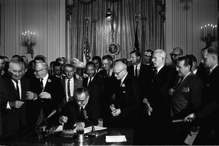 President Lyndon B. Johnson signs the Civil Rights Act of 1964