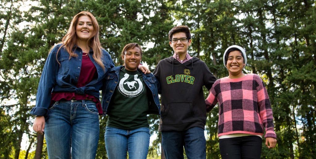 kids standing together in a forest setting