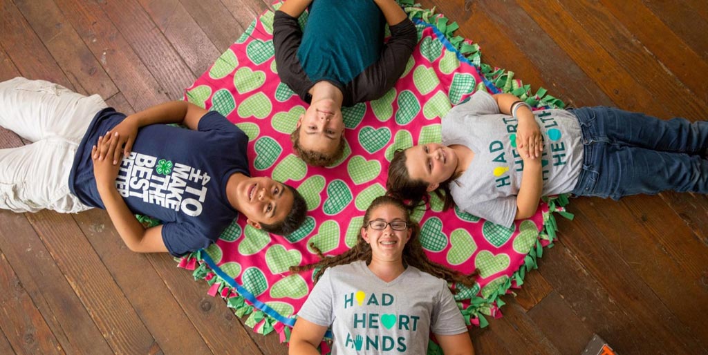 birds eye view of kids laying on floor in a circle