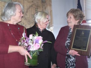 Barnstable County Commissioner Mary Pat Flynn, right, receives a special award of distinction from the Mercy Otis Warren Cape Cod Woman of the Year Committee on Feb. 6 presented by committee members Ann Canedy, left, and Alice George, center.