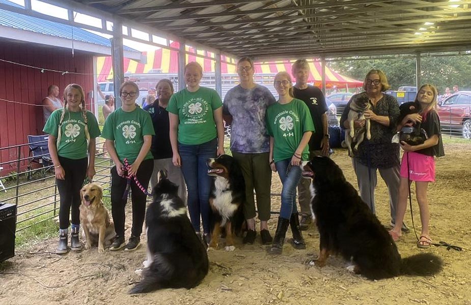 People with dogs in barn