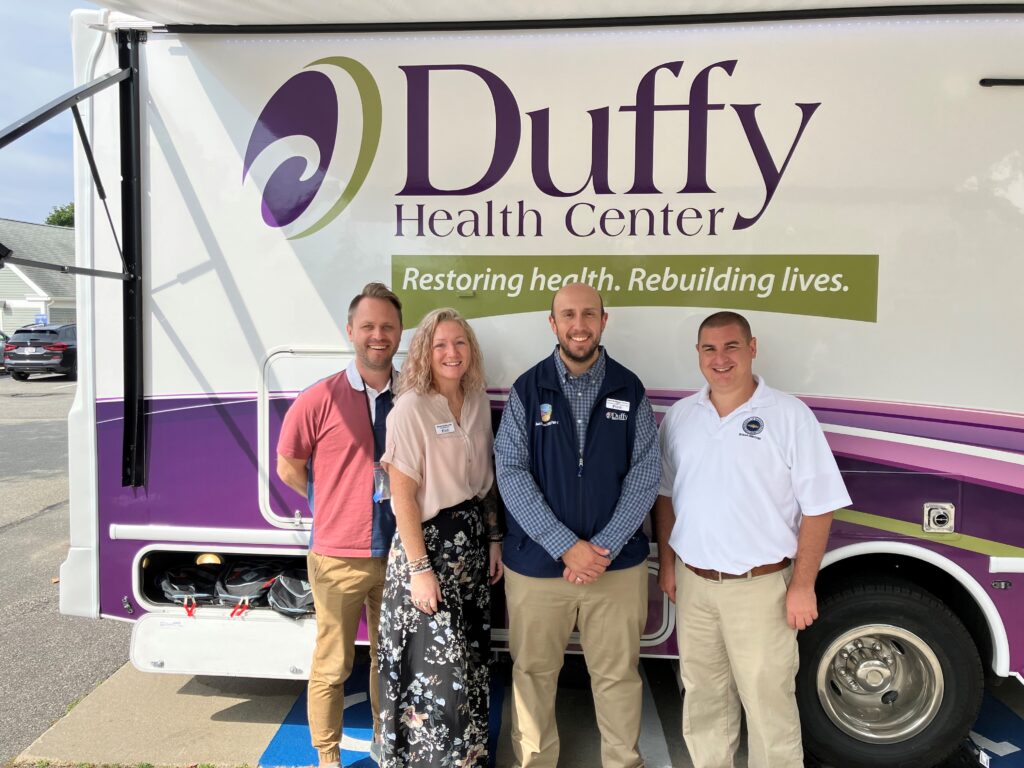 Joe Pacheco, Barnstable County Director of Human Services, pictured in front of the REACH Mobile Unit with Duffy Health staff.